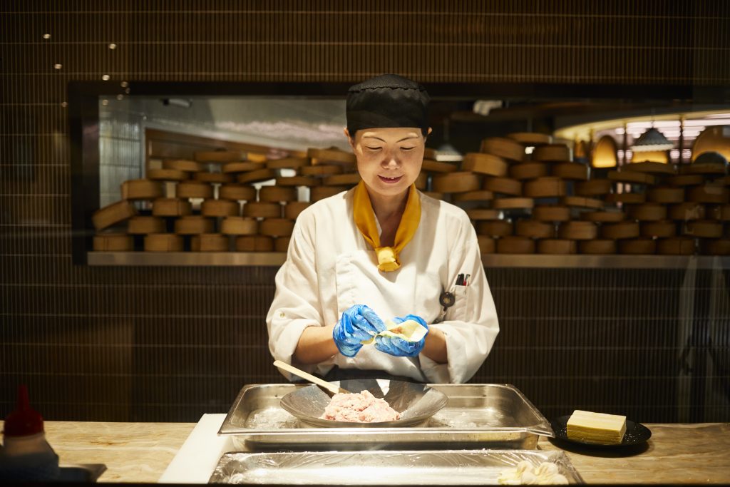 chef folds dumplings by hand