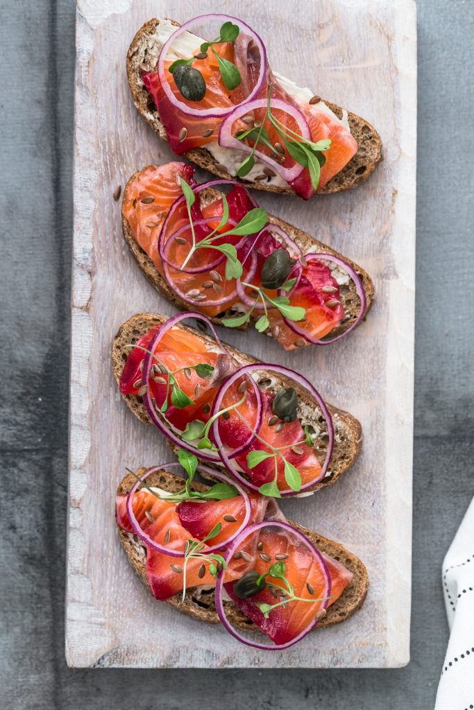 Cured salmon gravlax on a crusty bread.