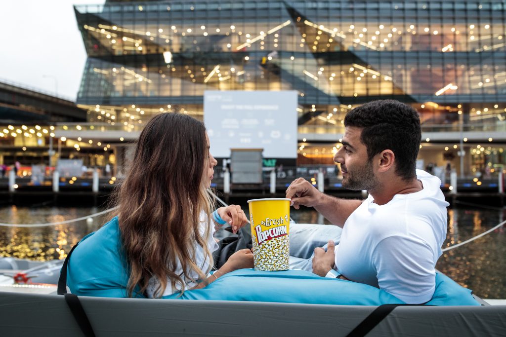 A couple share popcorn at the Mov'in Boat pop-up