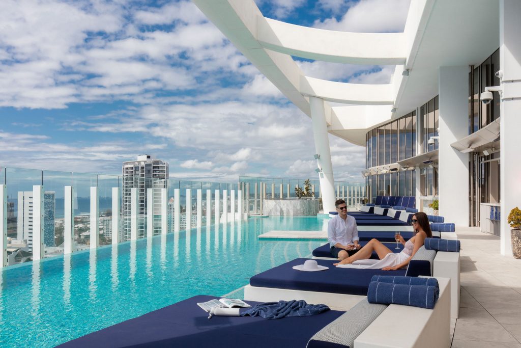 Couple lounging by rooftop pool