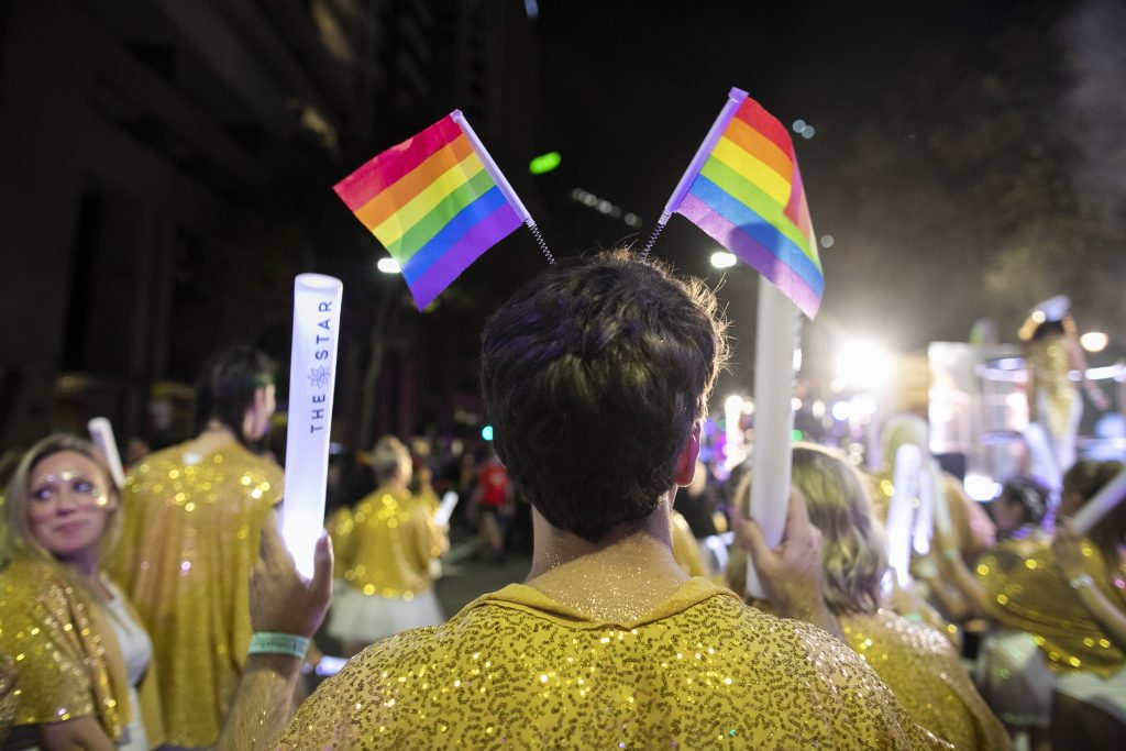The Star member wears Pride flags at the 2020 Mardi Gras parade
