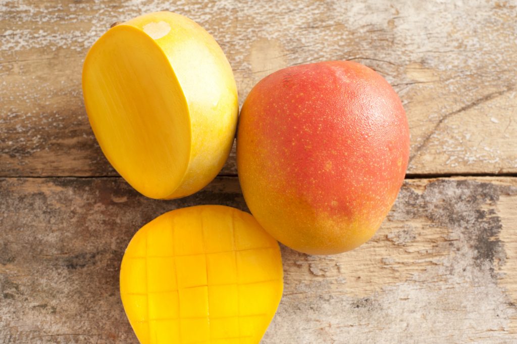 Fresh mangoes sliced on a table